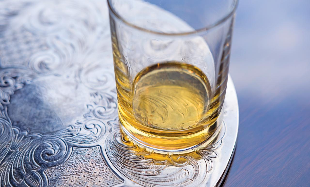 A glass of whisky rests on a table during a tasting event on the ship Lord of the Glens