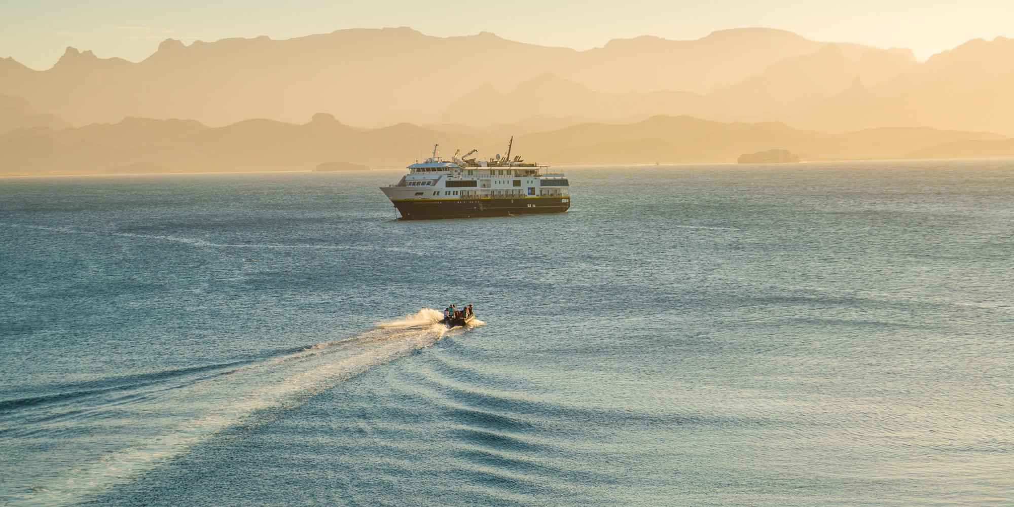 Guest heading back to the ship National Geographic Venture by zodiac in Honeymoon Cove, Bay of Loreto National Park, Baja California Sur, Mexico