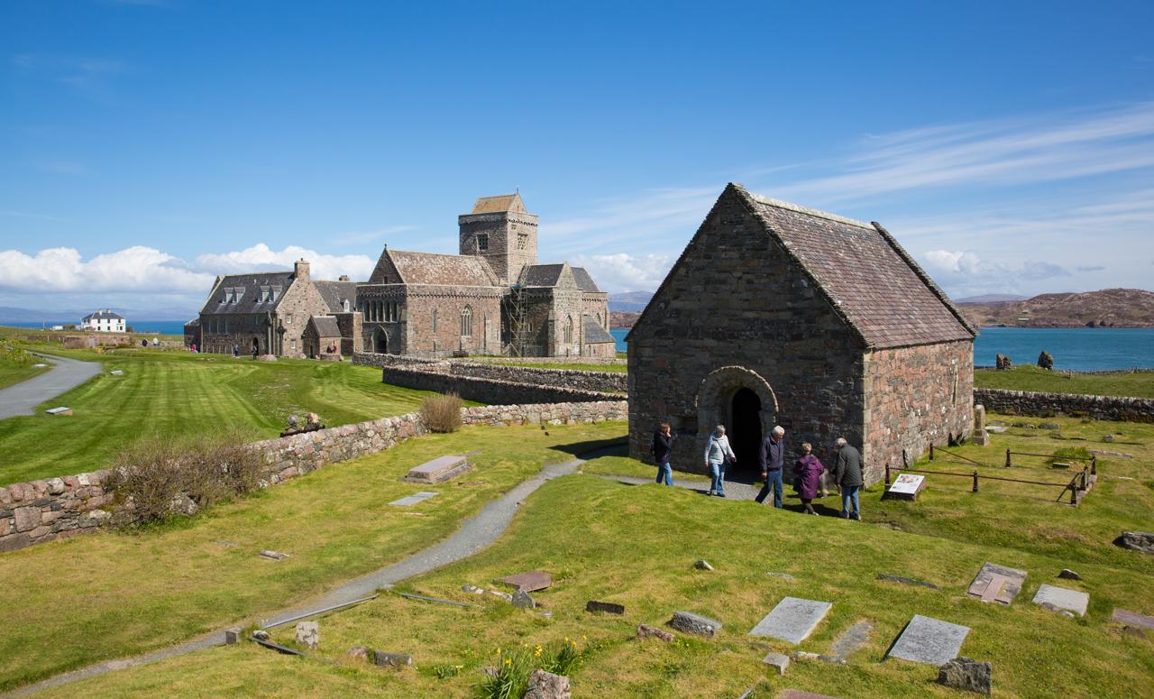 Guests enjoy the beautiful sunny spring weather exploring the historic Iona Abbey, Iona, Scotland.