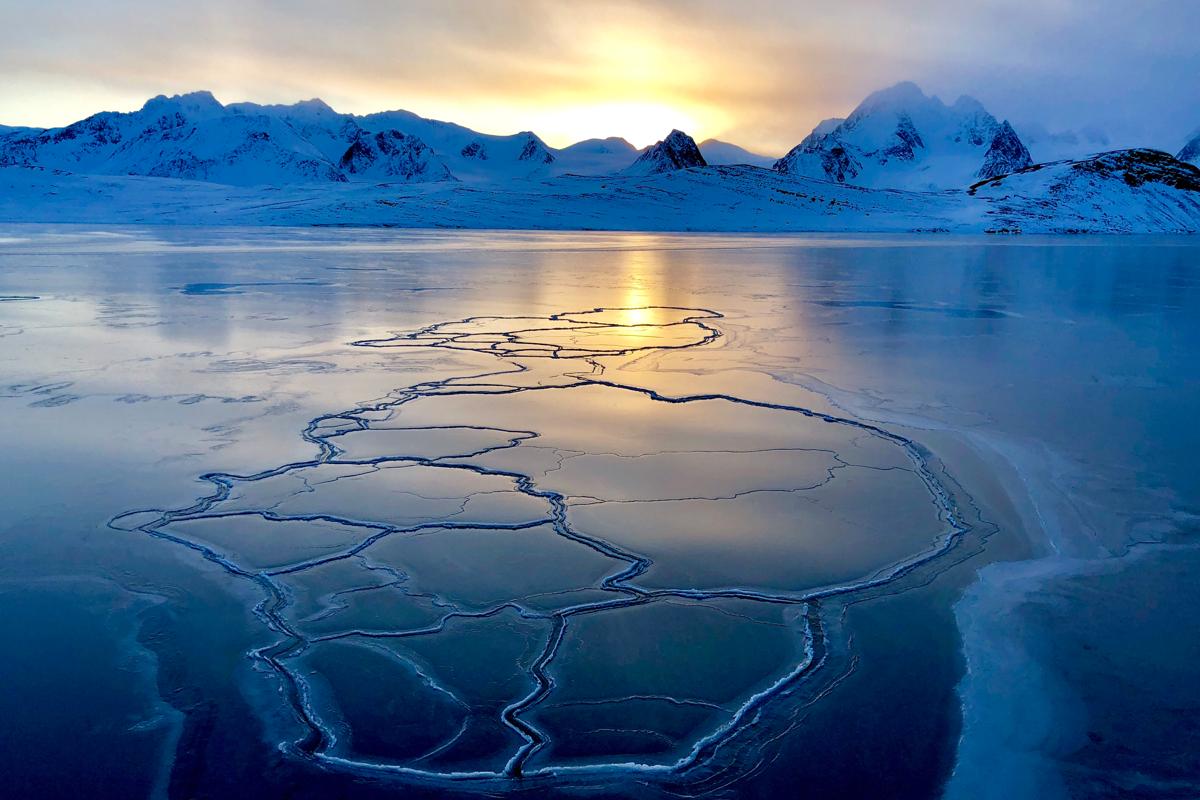 A sunrise view of the ice and mountains during the Reconnaissance voyage to the high Arctic