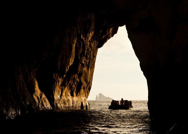 Guests adventure by zodiac in the rocky arch at Kicker Rock, San Cristobal Island, Galapagos Islands, Ecuador