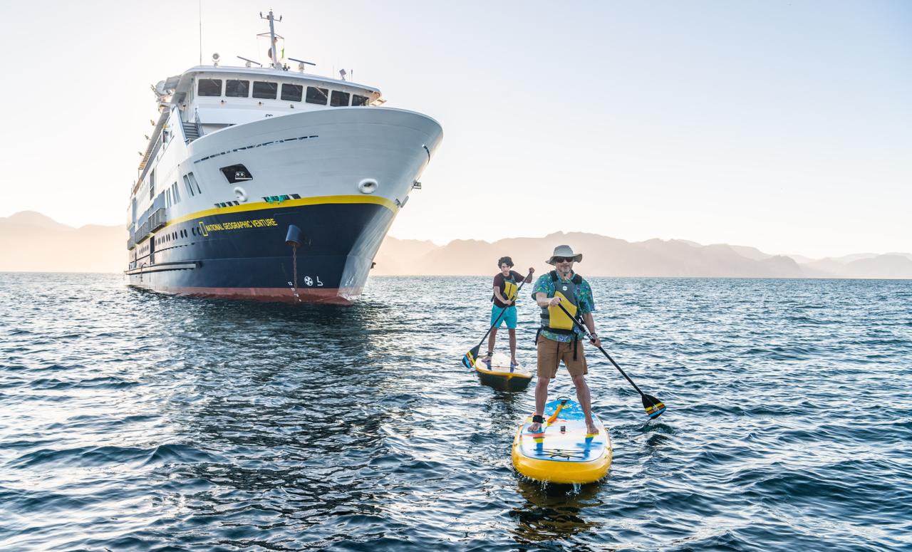 Guests Standup Paddleboarding  in San Evaristo from the ship National Geographic Venture, Baja California Sur, Mexico