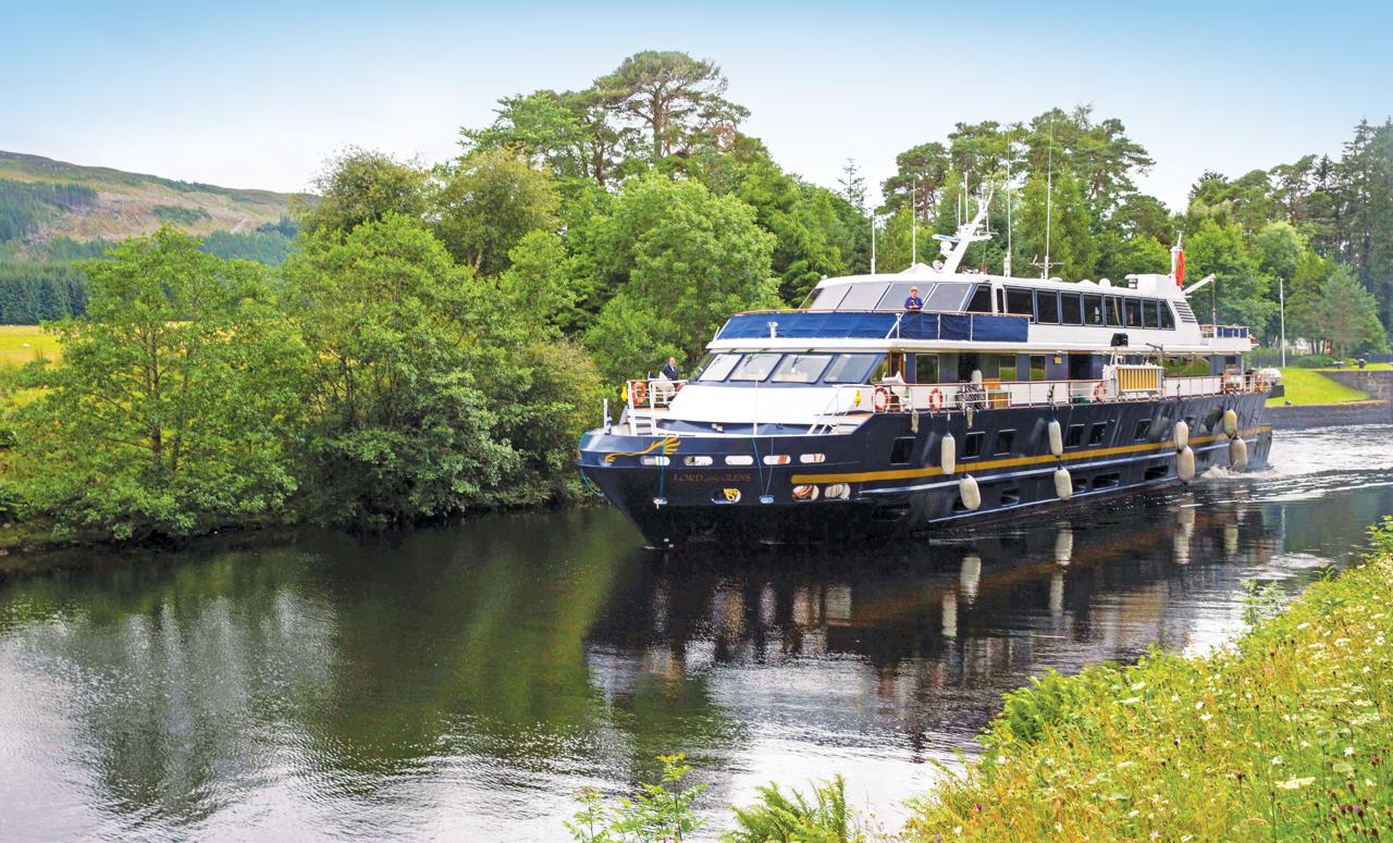 Ship Lord of the Glens cruises along the Caledonian Canal towards Fort Augustus, Scotland.