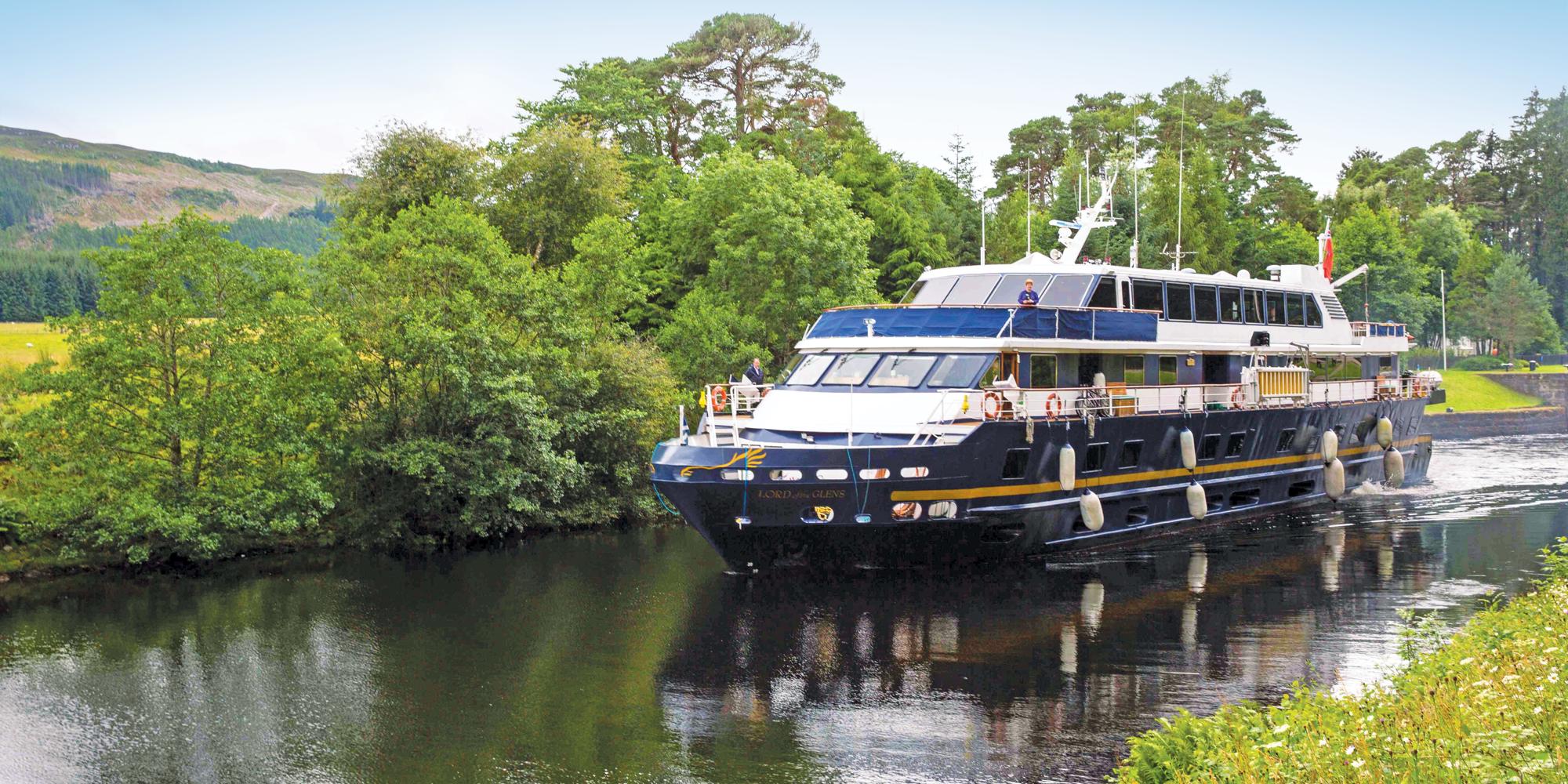 Ship Lord of the Glens cruises along the Caledonian Canal towards Fort Augustus, Scotland.