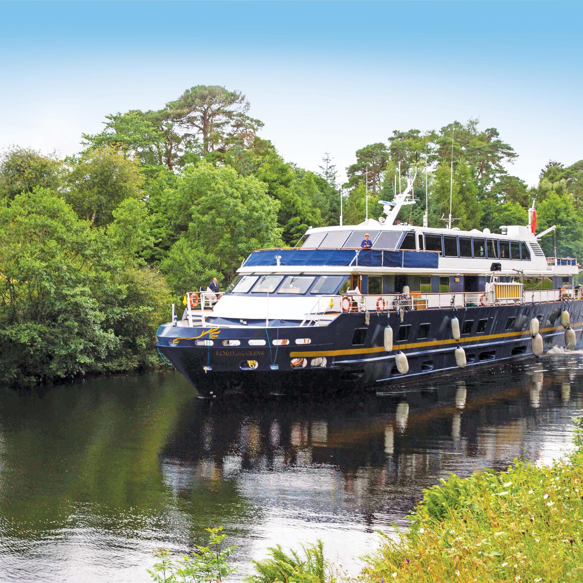 Ship Lord of the Glens cruises along the Caledonian Canal towards Fort Augustus, Scotland.