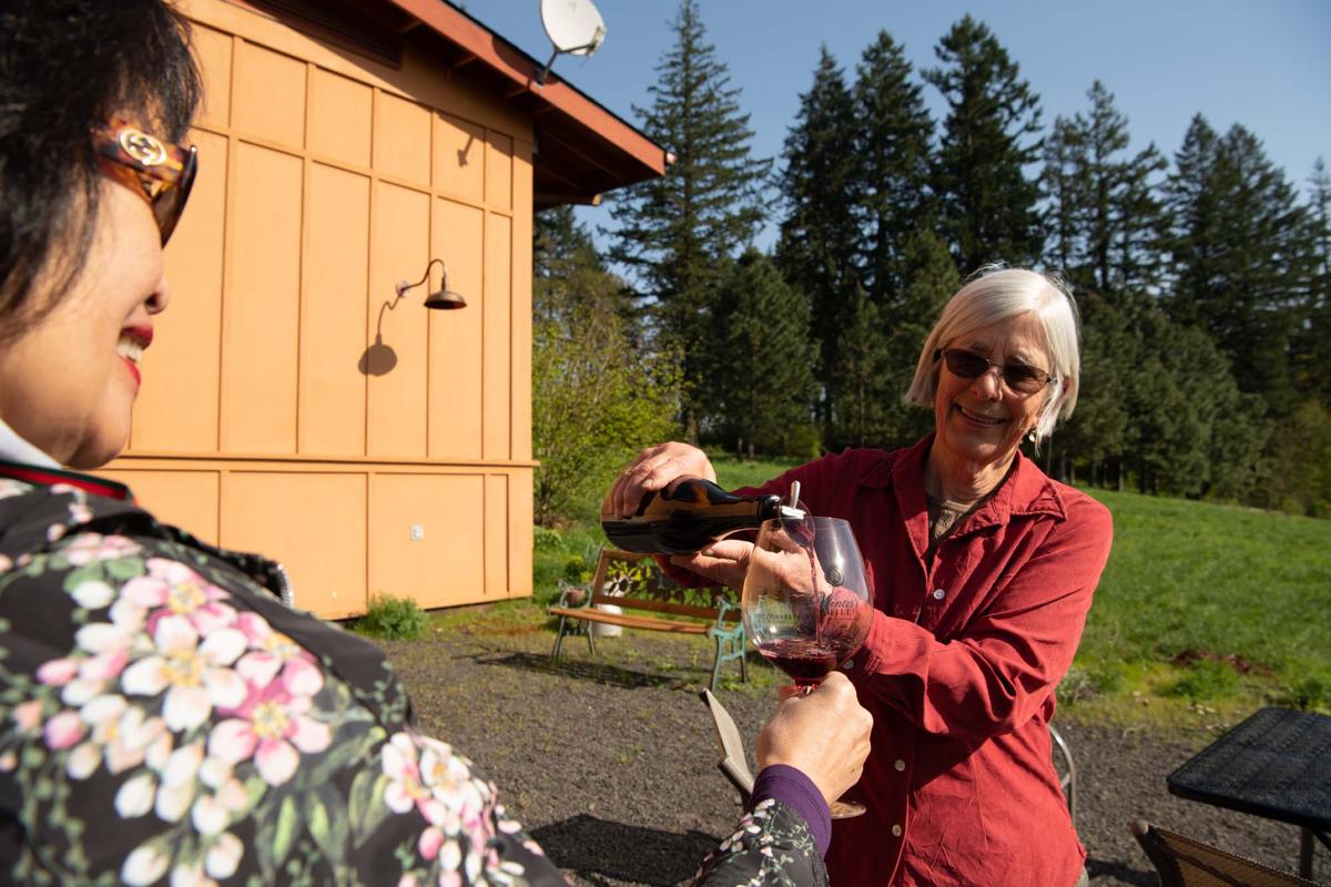 Owner of Winter's Hill Winery, Emily Gladhart, pouring wine for guests,  Dayton, Oregon