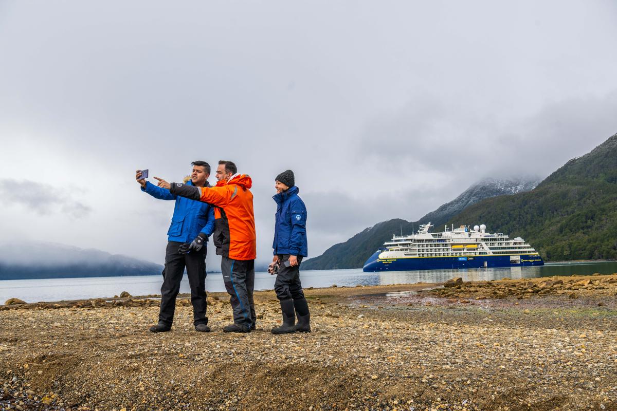 National Geographic Photography Expert, Kike Calvo, instructing guests on capturing the essence of Jackson Bay's allure in Karukinka National Park, Patagonia, Chile.