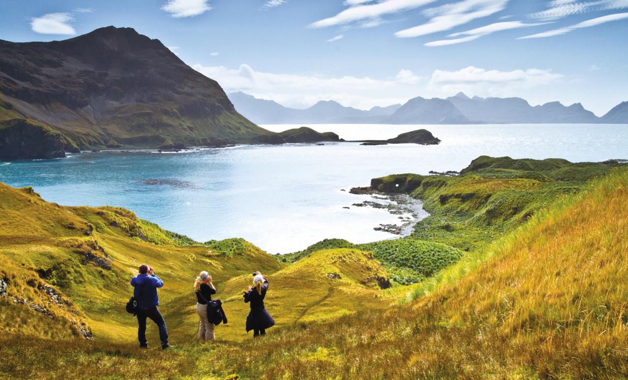 Guests photographing and hiking in South Georgia Island, Southern Ocean, Antarctica