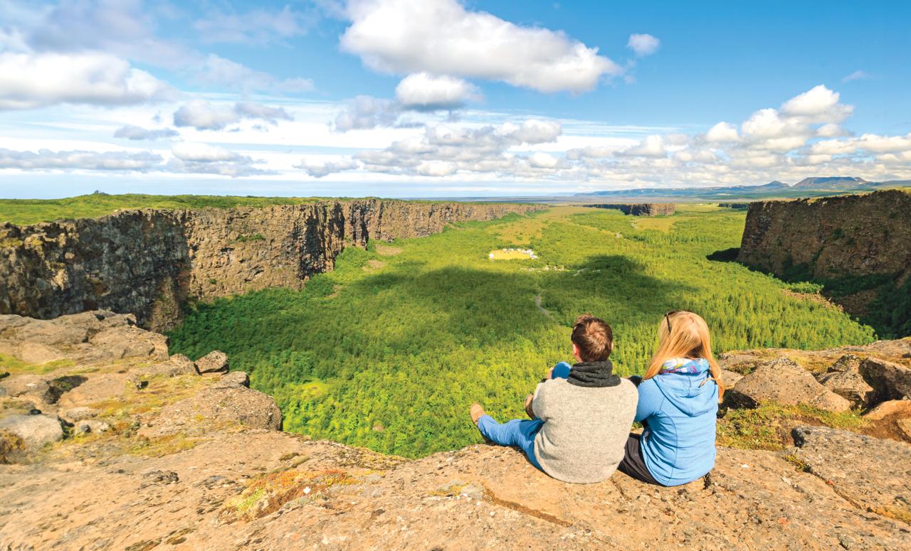 Relaxing with a view - hikers at Ásbyrgi canyon, Jokulsargljufur, Iceland.